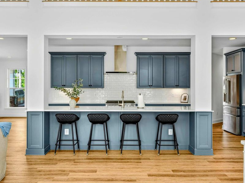 Kitchen Island - Four counter-height bar stools line the large island, the heart of every breakfast and late-night snack.