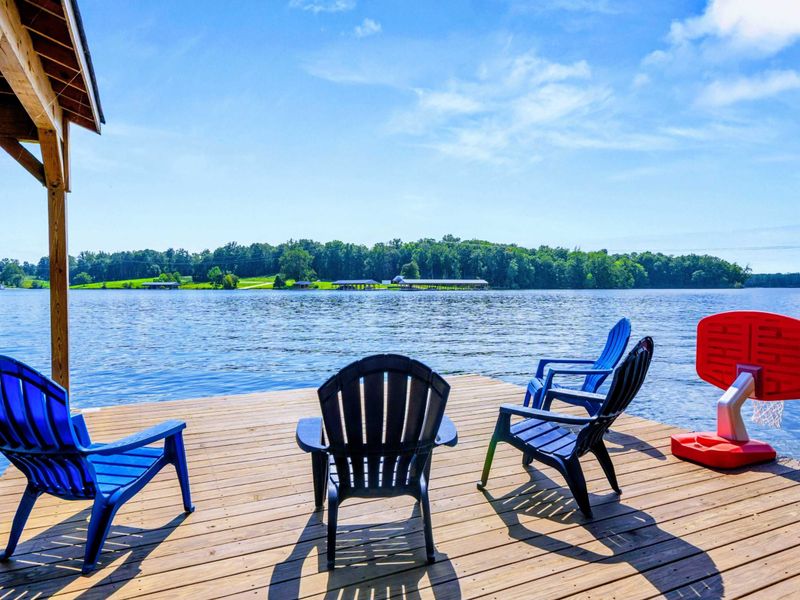 Dock Seating - Bright Adirondack chairs and a basketball hoop turn the end of the dock into the favorite hangout spot.