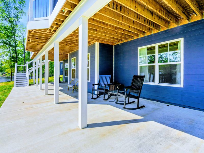 Covered Porch - Wraparound space beneath the upper deck, with rockers and easy access out to the lawn and fire pit.