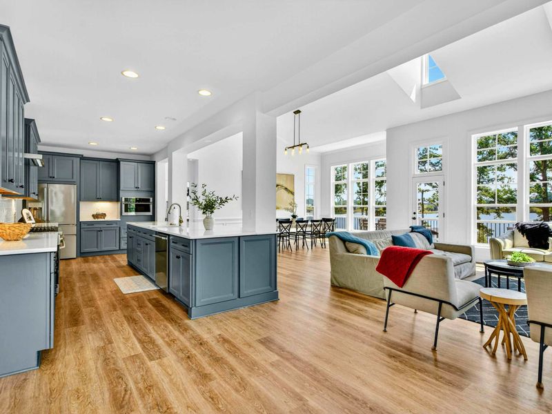 Kitchen & Living - The slate-blue kitchen island and open floor plan keep the chef in the conversation while everyone gathers.