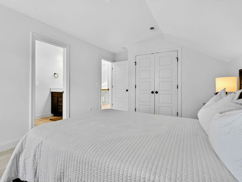Upper Bedroom - The queen bedroom features a spacious layout with closet space, ensuite access, and a calm, neutral palette.