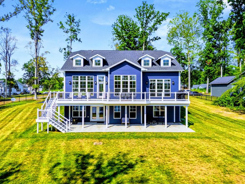 Side Exterior - The Shoreline's classic blue siding and white trim sit on a wide, private corner lot with room to spread out.