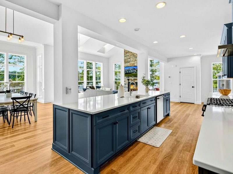 Kitchen & Dining - Pendant lights, white quartz island, and an open layout that flows from breakfast to sunset over the lake.