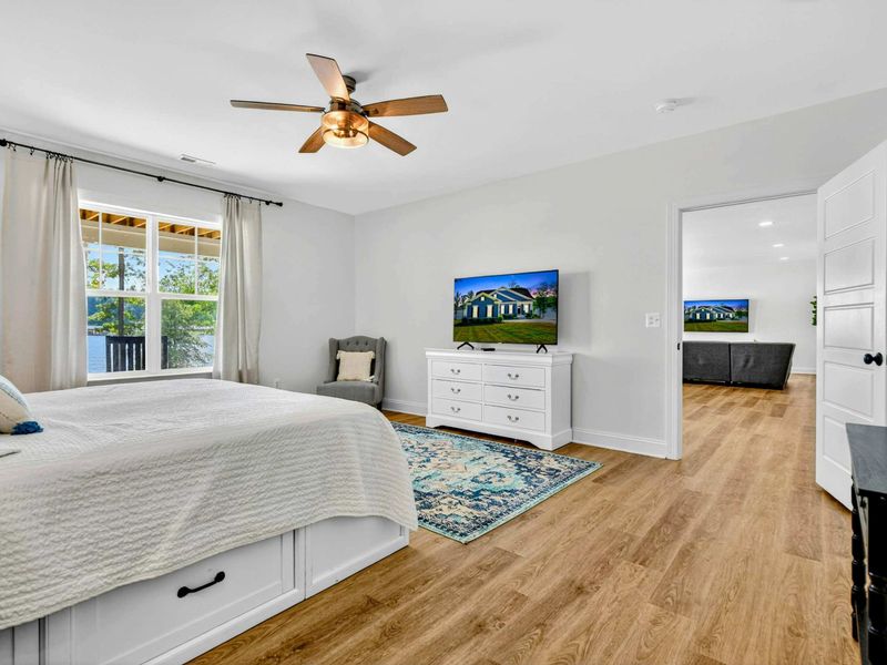 Main Level Bedroom - The king bedroom features a Smart TV, ceiling fan, and lake views just outside the window.