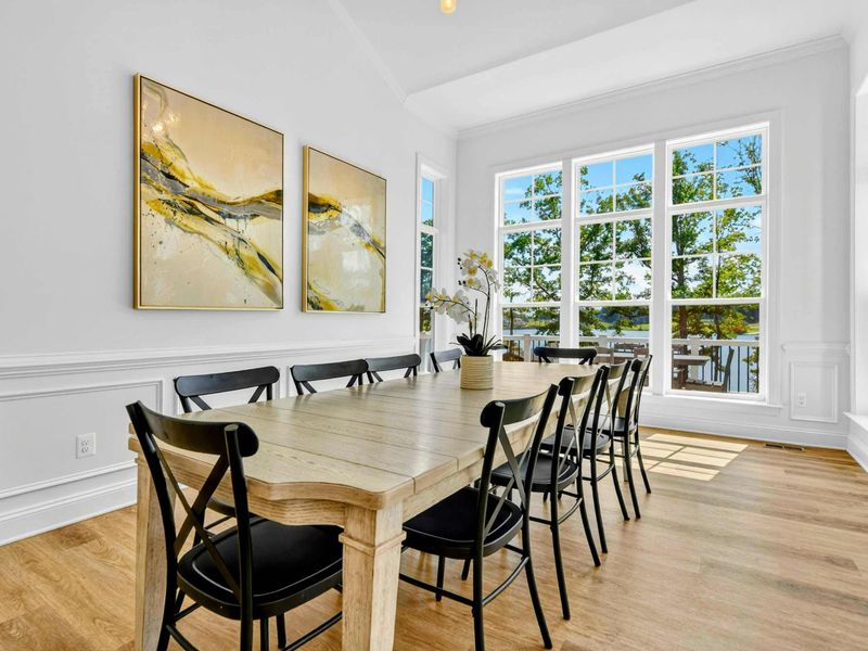 Dining Room - The full-length dining table is perfectly placed beside oversized windows that flood the room with lake light.