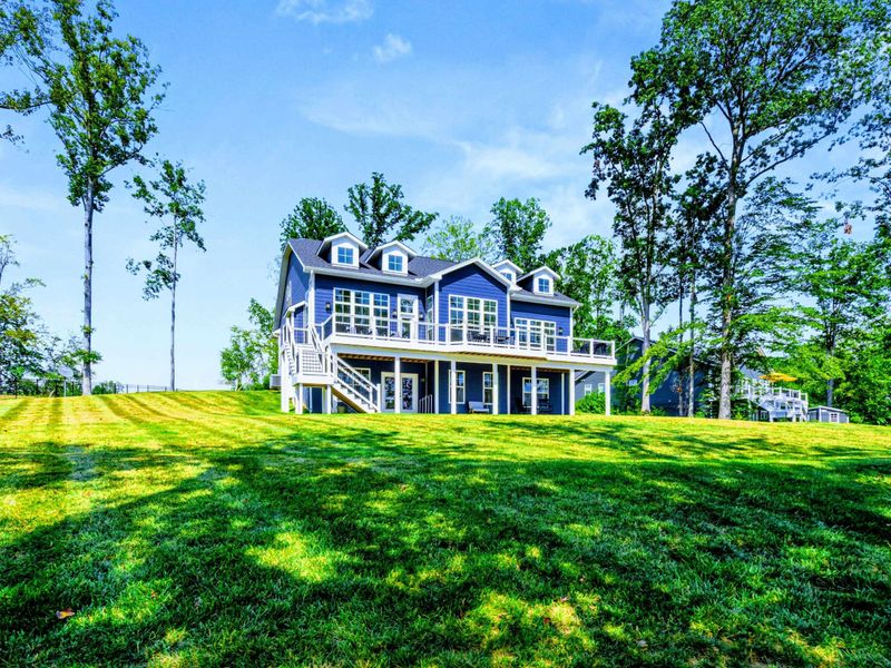 Lake-Side Exterior - The full three-story rear facade rises above an expansive lawn that rolls right down to the lake.