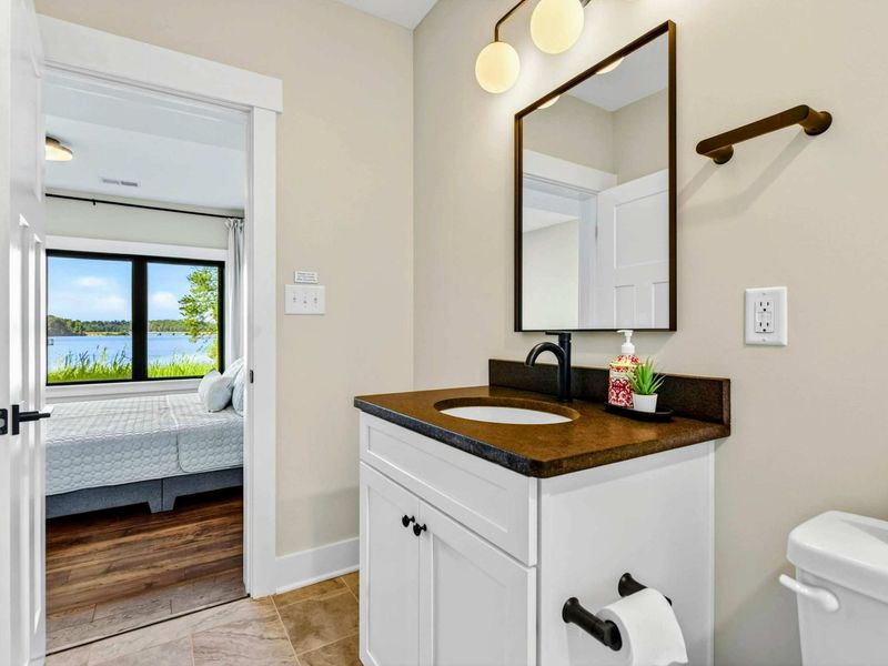 Bathroom 5 - Vanity with view through the doorway to the lake level bedroom and its waterfront window.
