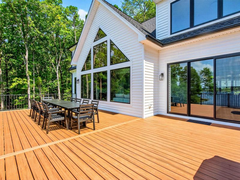 Main Deck - The A-frame window wall towers over the outdoor dining area on the upper deck.