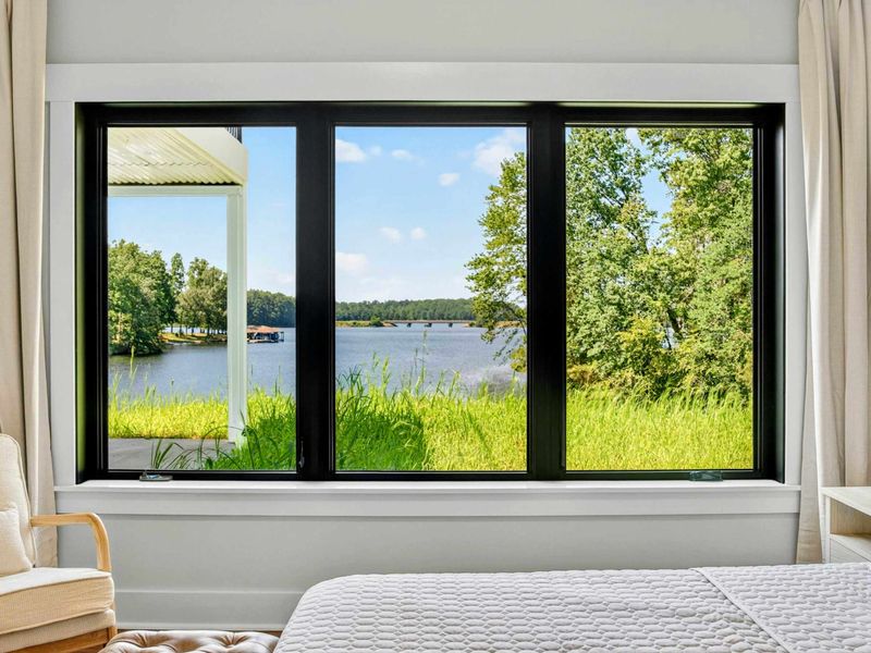 Bedroom 5 - Lake views from the bed with the covered patio columns framing the waterfront.