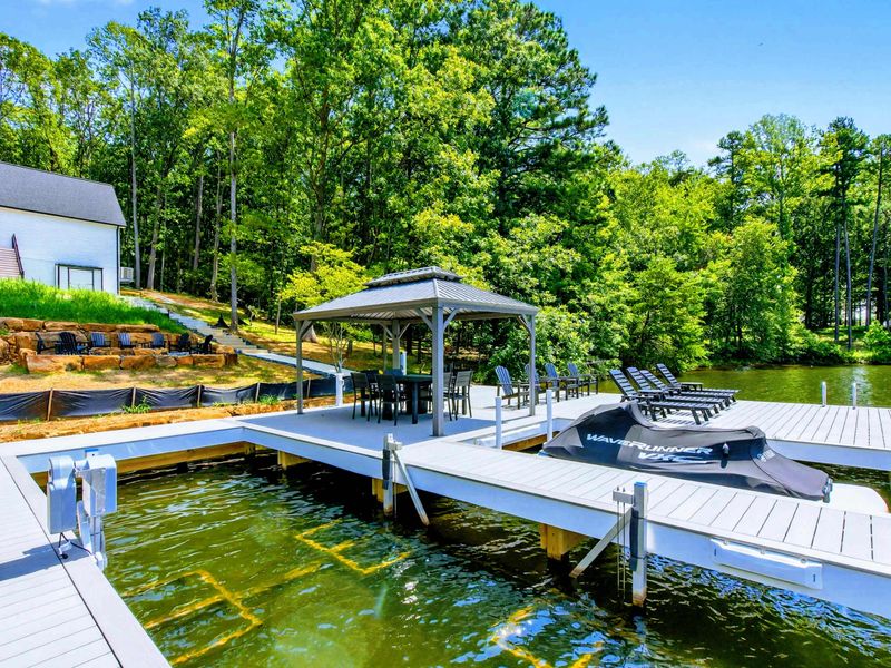Private Dock - Side view showing the boat slip, gazebo, and chaise loungers over the water.