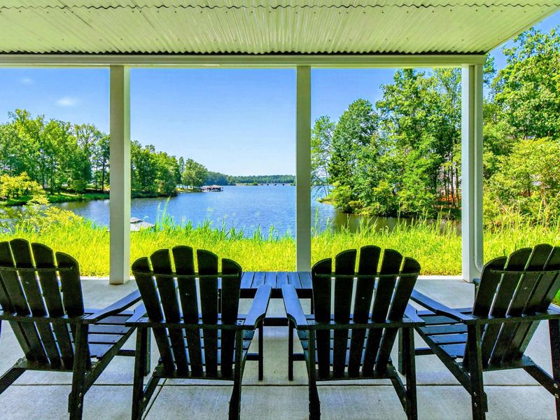 Covered Patio - Adirondack chairs line the lower patio with views straight out to the water.