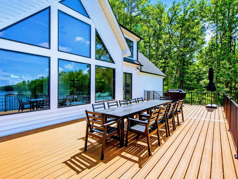 Main Deck - Full deck view with dining, grill, and the dramatic peaked window wall above.