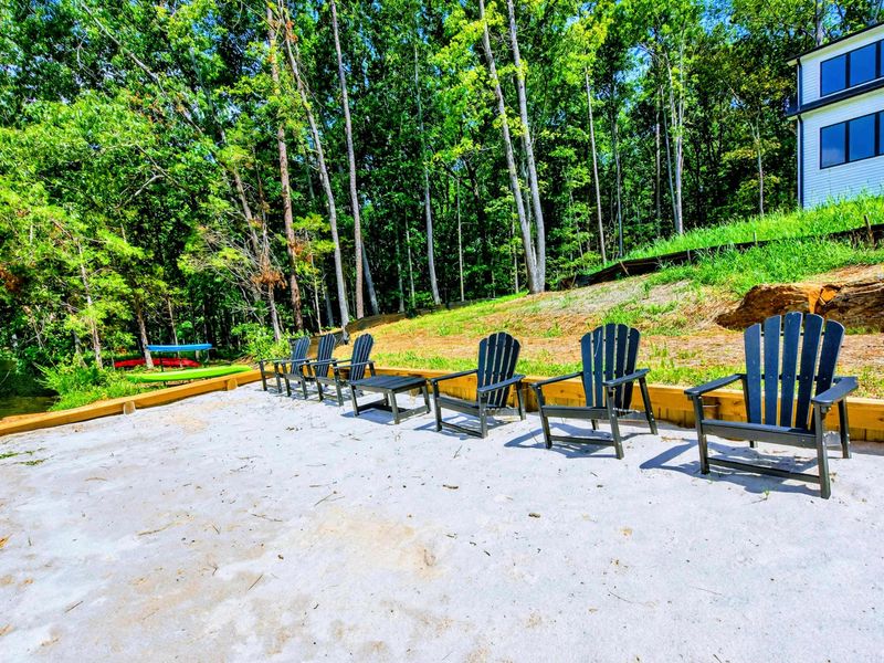 Sandy Beach - Private beach with Adirondack chairs and a gentle slope up to the house.