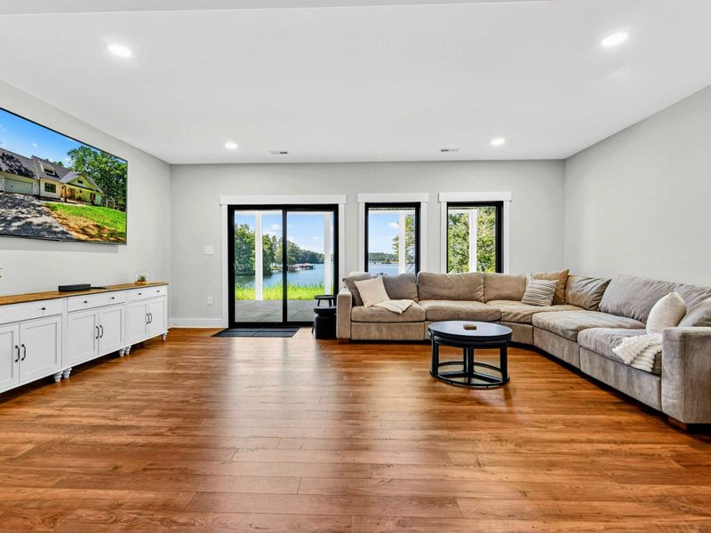 Lower Level Family Room - Comfortable seating and a big screen with sliding doors to the covered patio.