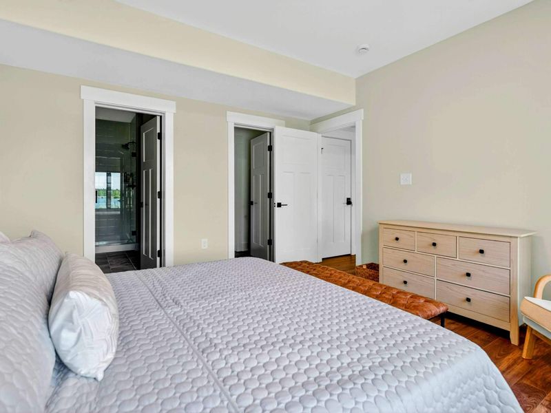Bedroom 5 - Reverse view showing the private ensuite entry with dark tile and walk-in closet.