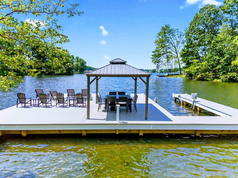 Private Dock - Spacious dock with covered gazebo, Adirondack seating, dining table, and boat slip.