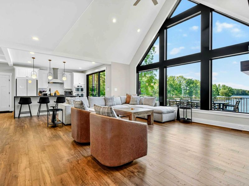 Open Floor Plan - The great room flows into the chef's kitchen beneath soaring vaulted ceilings with lake views.
