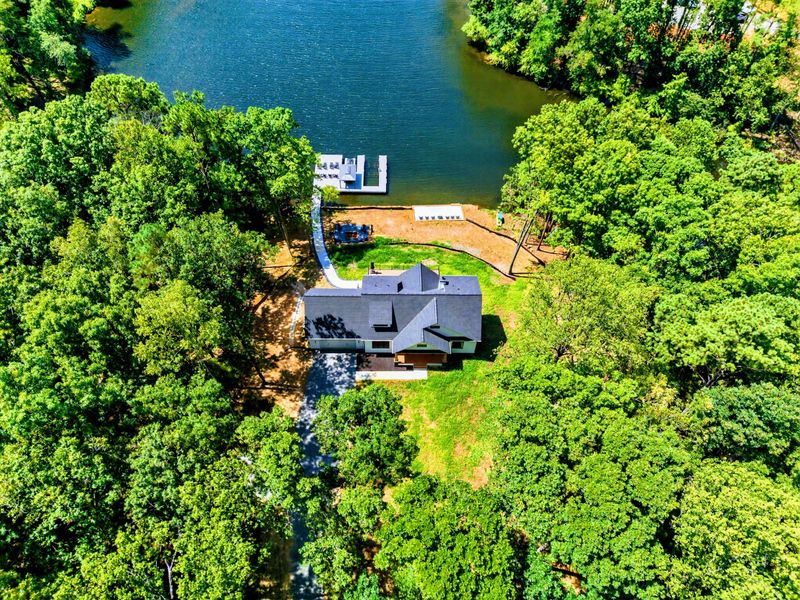 Aerial View - Wider perspective showing the wooded lot and dock on the private cove.