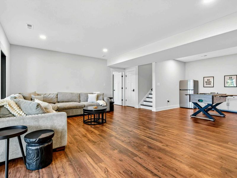 Lower Level - The family room opens to the game area with foosball table and kitchenette.