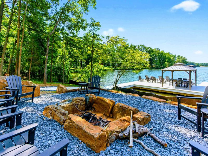 Fire Pit - Boulder-ringed fire pit with Adirondack chairs for lakeside evenings under the stars.