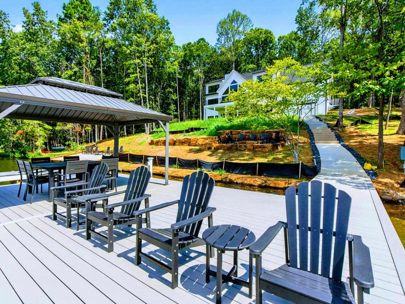 Dock Seating - Adirondack chairs and covered gazebo create a lakeside gathering spot.