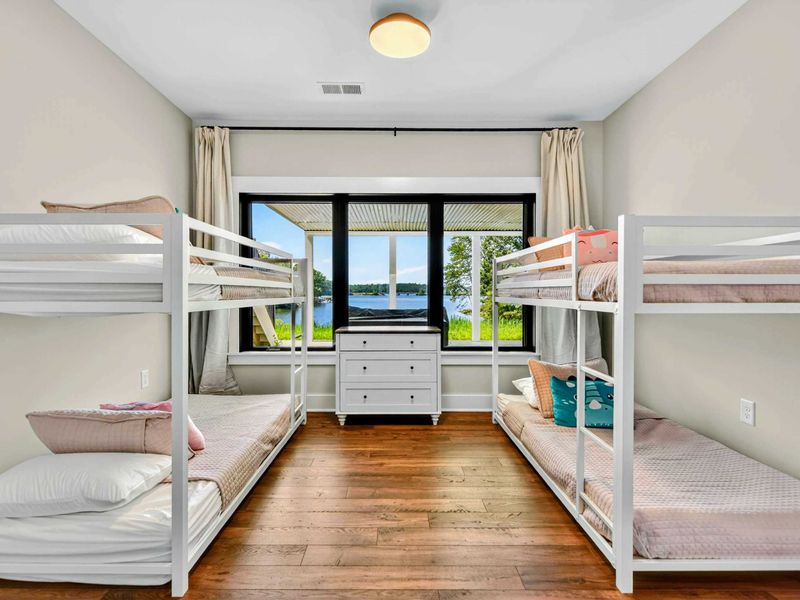 Bunk Room - Two sets of twin-over-twin bunk beds with a lake view window between them.