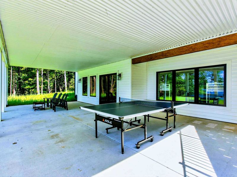 Covered Patio - Lower level covered patio with ping pong table and Adirondack chairs facing the lake.