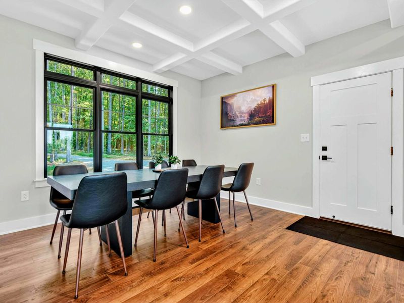 Dining Area - Landscape artwork and front entry complement the elegant dining space.