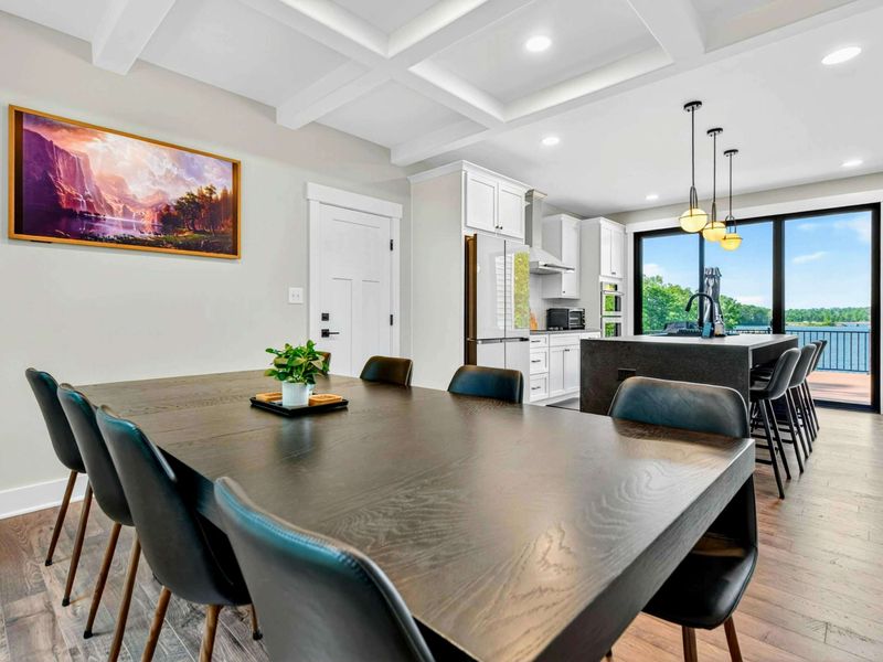 Dining Area - The dining space connects to the kitchen with lake views visible through the slider beyond.