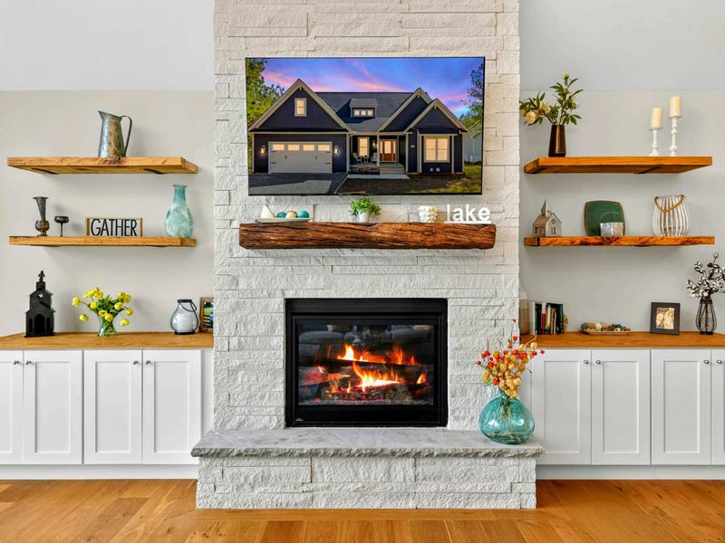 Fireplace Feature Wall - So many custom details make Blueberry Bay a unique vacation spot. The floor-to-ceiling stone fireplace, framed by floating shelves, built-in cabinetry, and curated décor, perfectly blends rustic charm with modern luxury!