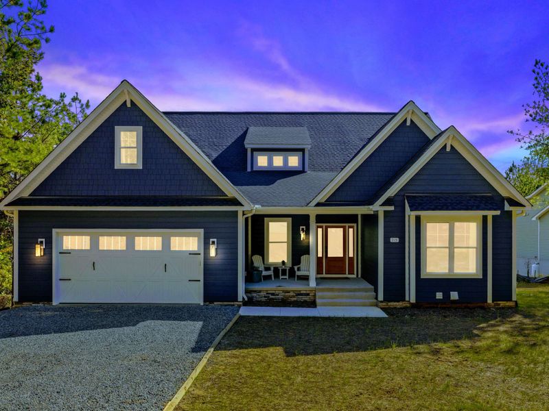 Twilight Welcome - Warm interior light spills through the windows as evening settles over the home.