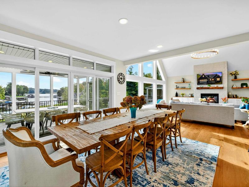 Dining to Lake -Our Restoration Farmhouse long table seats 10+ with cross-back chairs, overlooking the kitchen island & of course gorgeous lake views! Perfect for fueling up before a day at the lake or evenings of story telling of the days adventures