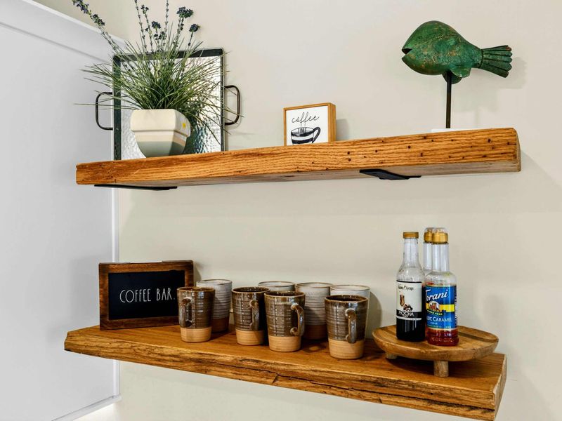 Coffee Bar Detail - Stoneware mugs, Torani syrups, and a "COFFEE BAR" sign on live-edge shelves make mornings feel special.