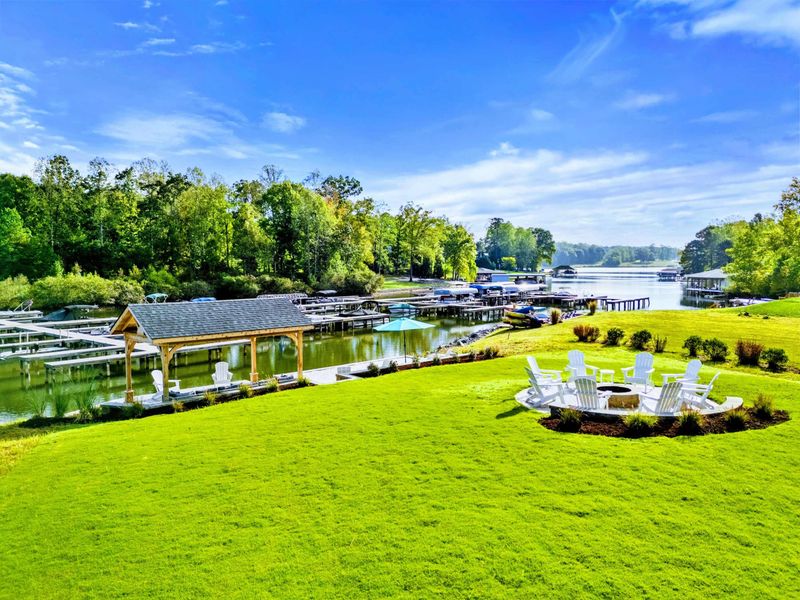 Aerial Overview - A bird's-eye view of the full property showing the dock, pavilion, fire pit, and sweeping lake panorama. Pictures don't do this view justice.