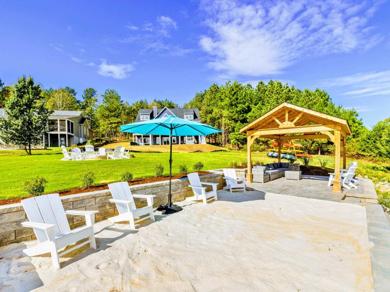 Pavilion and Patio - Our waterfront area has it all! With the beach, covered pavillion, hot tub, fire pit and all the water toys, guests have their own private oasis and will never want to leave!