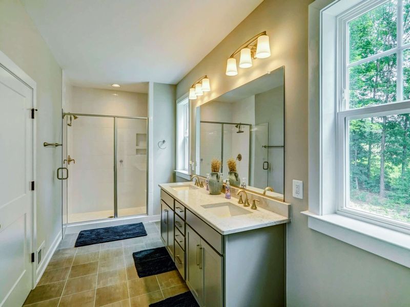Large Primary Suite bathroom with dual sink vanity, and a nice shower.