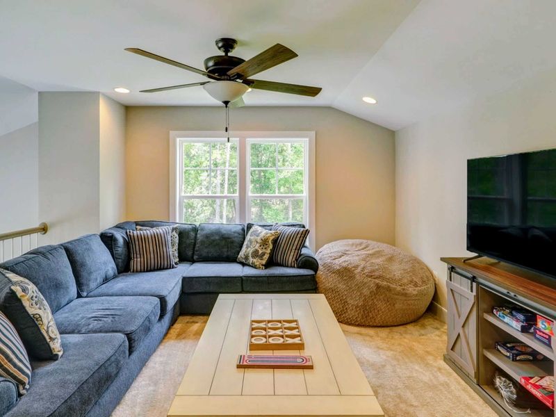 Upstairs loft (3rd living area) with TV and games.