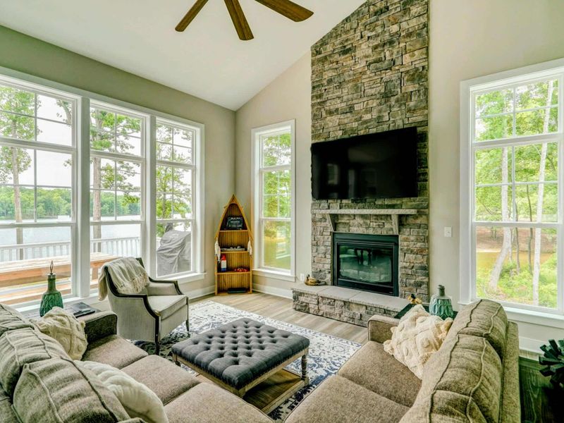 Open living room with amazing water views, comfy couch, Smart TV, and gas fireplace!