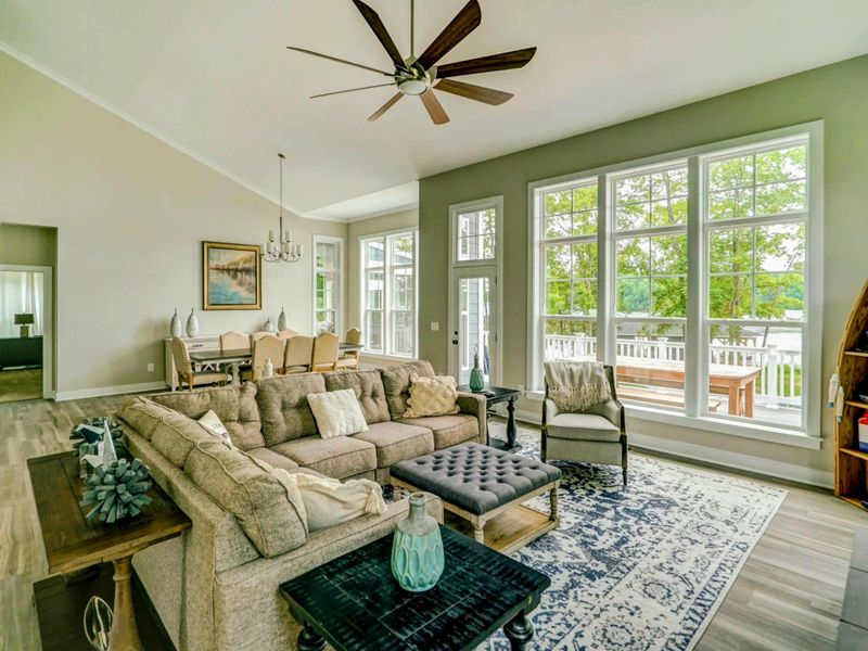 Open living room with amazing water views, comfy couch, Smart TV, and gas fireplace!