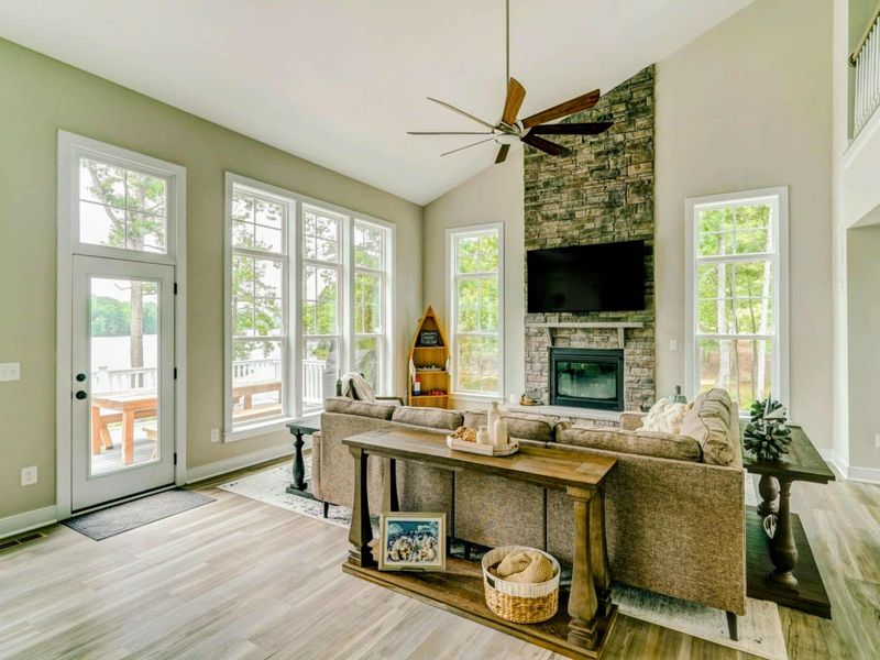 Open living room with amazing water views, comfy couch, Smart TV, and gas fireplace!