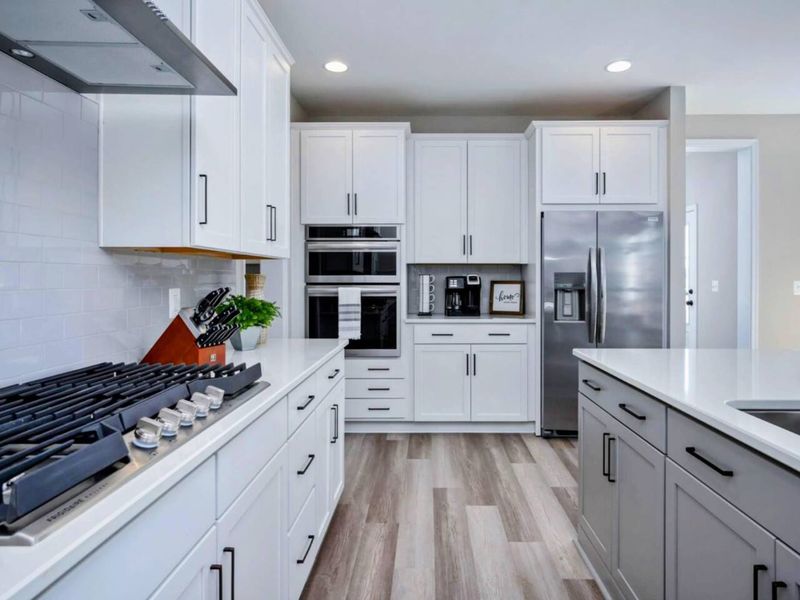 Cooking Station - Six-burner gas cooktop, double oven, microwave, and full-size fridge: a setup serious cooks recognize.