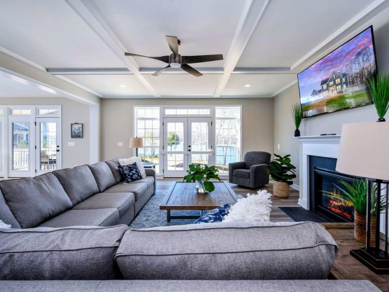 Great Room - Coffered ceiling, a generous sectional, and a wall of French doors that pulls the lake right into the room.