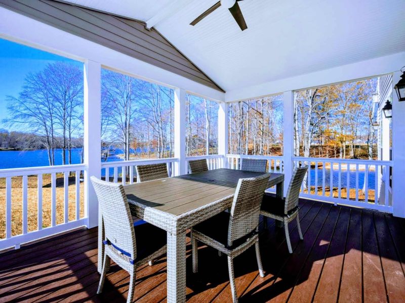 Screened Porch - A second seating area on the porch, ceiling fan overhead, and unbroken cove views in every direction.