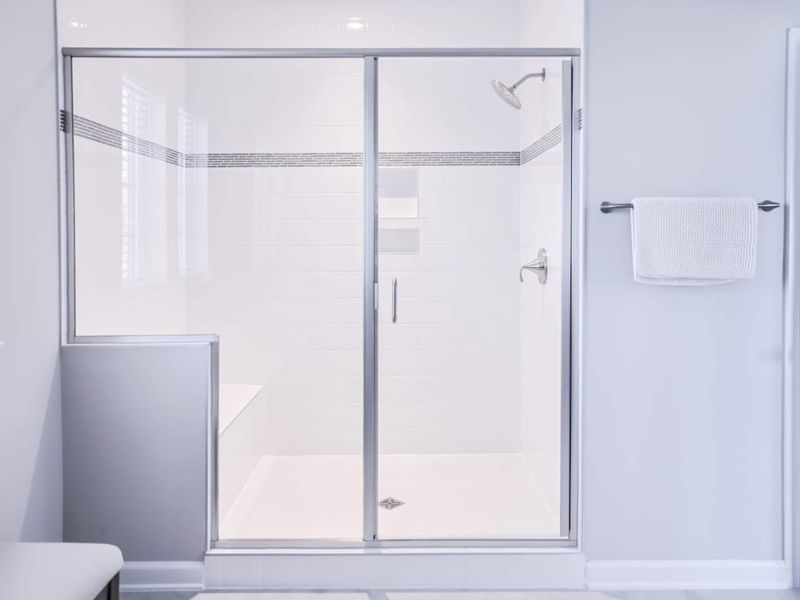 Walk-in Shower - Tile surround, built-in bench, and a rain head: the kind of shower that earns extra time at the end of the day.