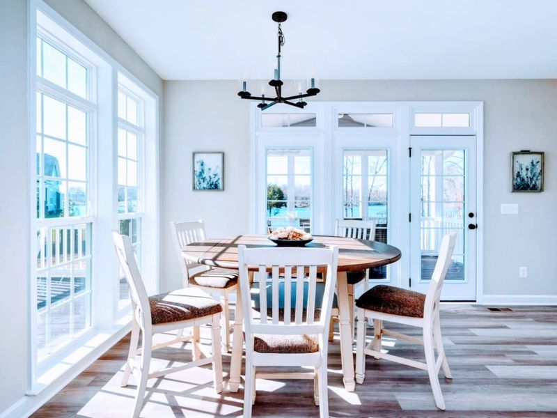 Breakfast Nook - Round table for five, lantern light overhead, and French doors opening out to the screened porch and lake.