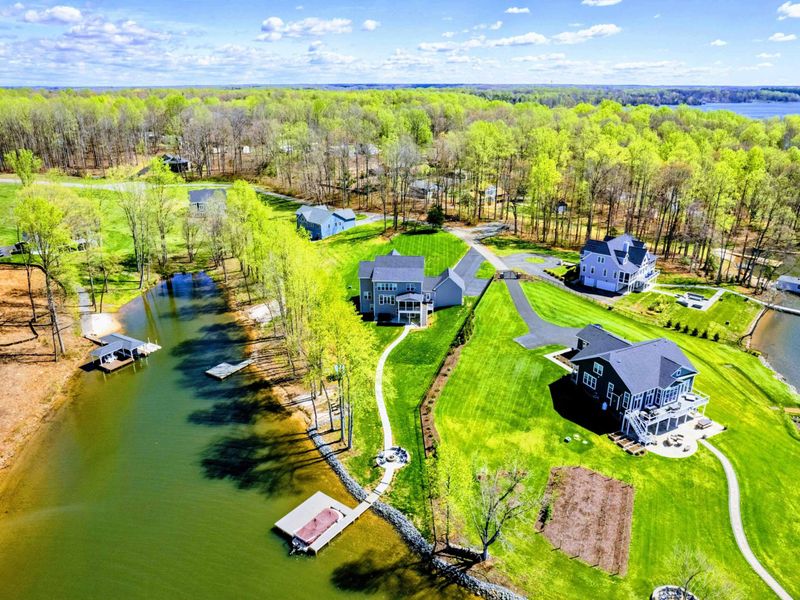 Aerial - Private dock, large lawn, and a wide stretch of cove with room for the boat to come and go without traffic.