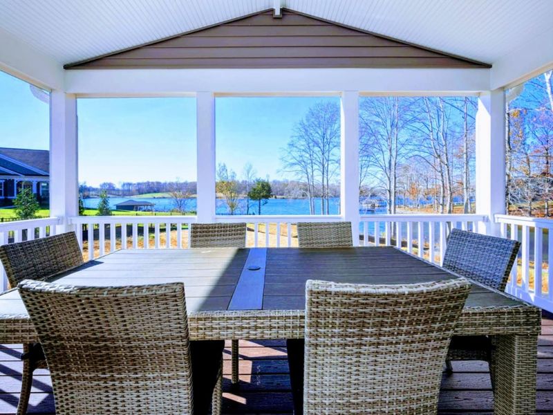 Screened Porch - Wicker dining for eight with the lake right outside, dinner outdoors without a single bug to swat.