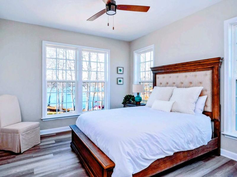 Main Level Queen Suite - Carved wood frame, tufted upholstery, and lake views right outside: a polished room with the easiest access.
