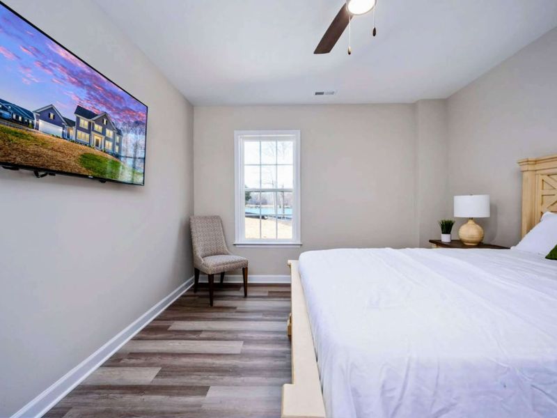 Lower Level Queen - Wall-mounted TV across from the bed, plenty of floor space, and a hardwood-style floor that wears well.