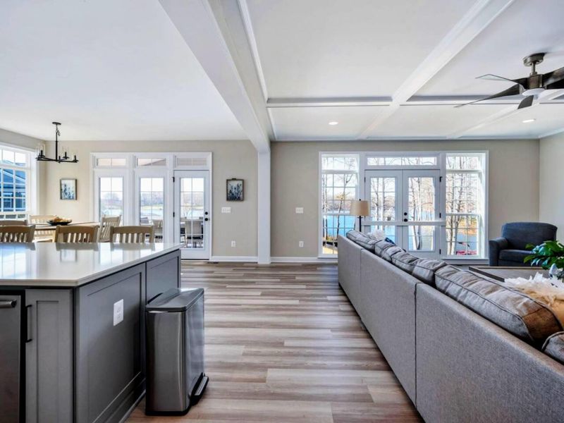 Open Layout - Kitchen, living room, and lake all in one frame, with French doors that open straight onto the back deck.